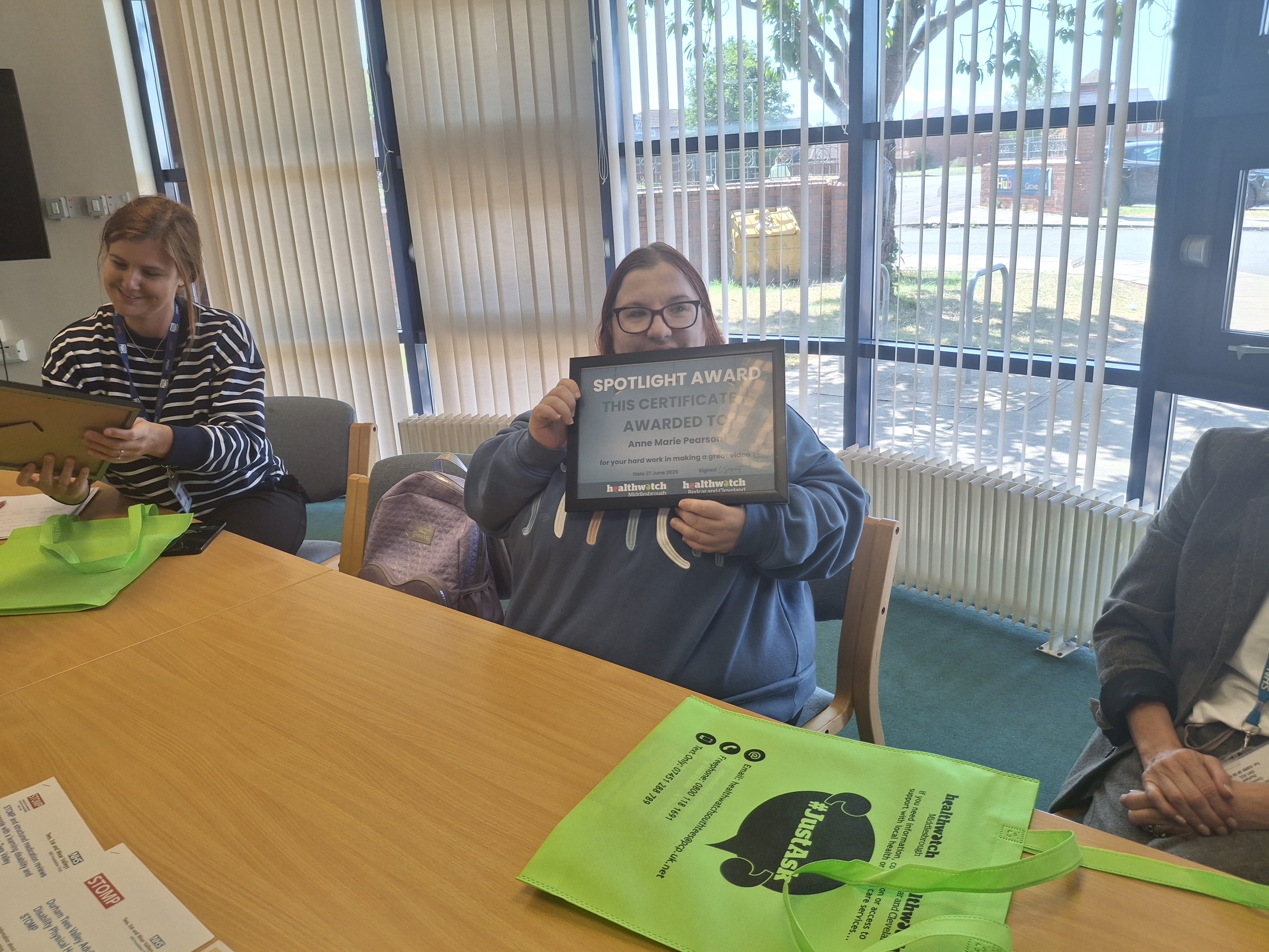 Ann Marie who wrote the script holding her certificate up