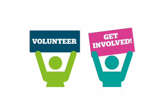 Volunteers holding a Healthwatch poster